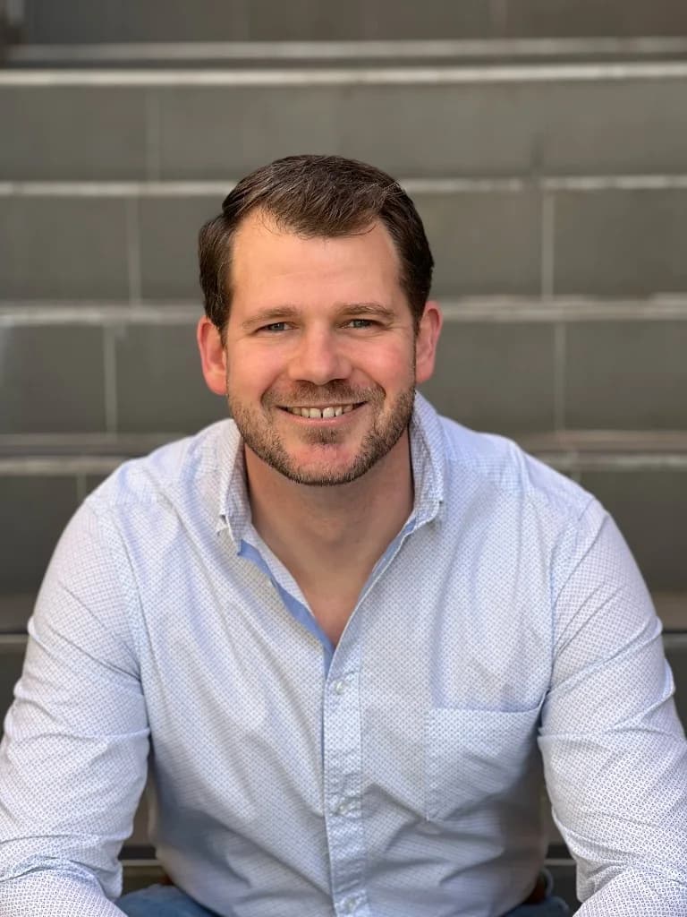 Founder of Then Wot? Sean Smith head shot wearing a business shirt and facing directly to camera capturing his upper torso